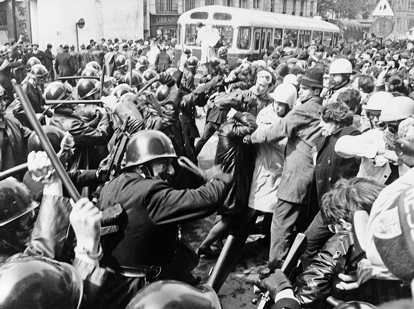 Students and police clash in Paris with clubs raised, police rush student demonstrators in the university district on May 6, 1968.