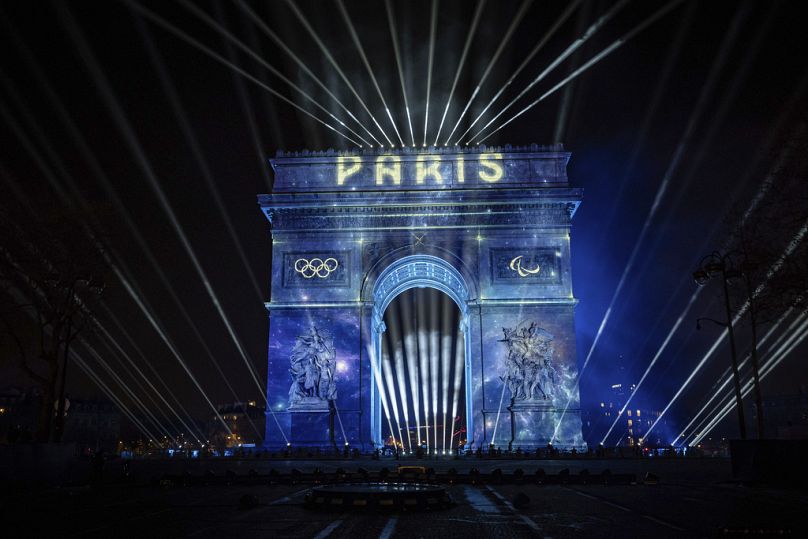 A light show is projected on the Arc de Triomphe during New Year celebrations on the Champs Elysees in Paris, January 2024