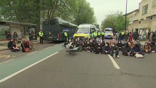 UK protesters block bus in attempt to stop asylum seekers from being moved to a barge