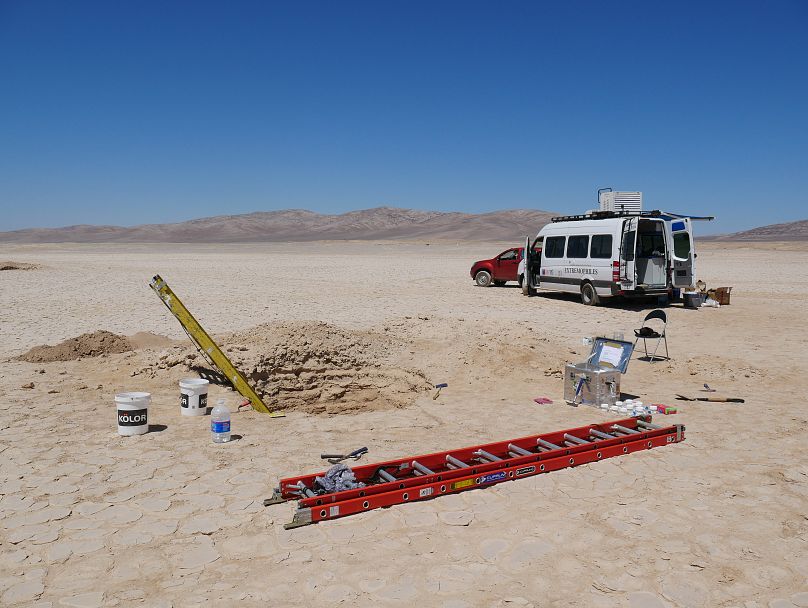The excavated profile pit and the laboratory trolley of the University of Antofagasta.