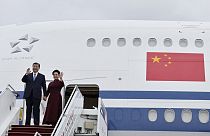 Chinese President Xi Jinping and his wife Peng Liyuan wave as they arrive at Orly airport, south of Paris, Sunday, May 5, 2024. 