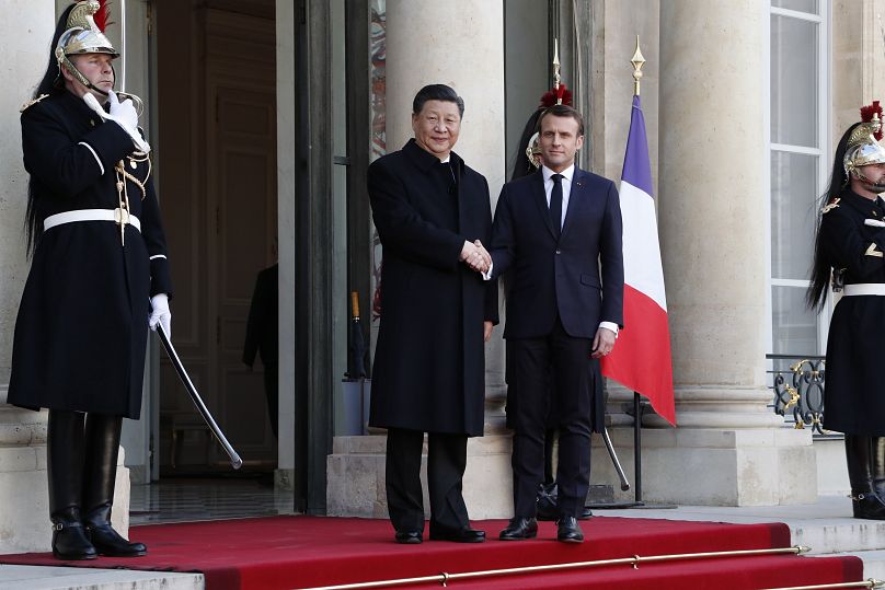 French President Emmanuel Macron, right, welcomes his Chinese counterpart Xi Jinping prior to a meeting at the Elysee Palace, in Paris, Monday, March 25, 2019.