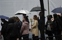 People gather in front of the Vladislav Ribnikar school during a memorial ceremony to mark the first anniversary of a shooting 