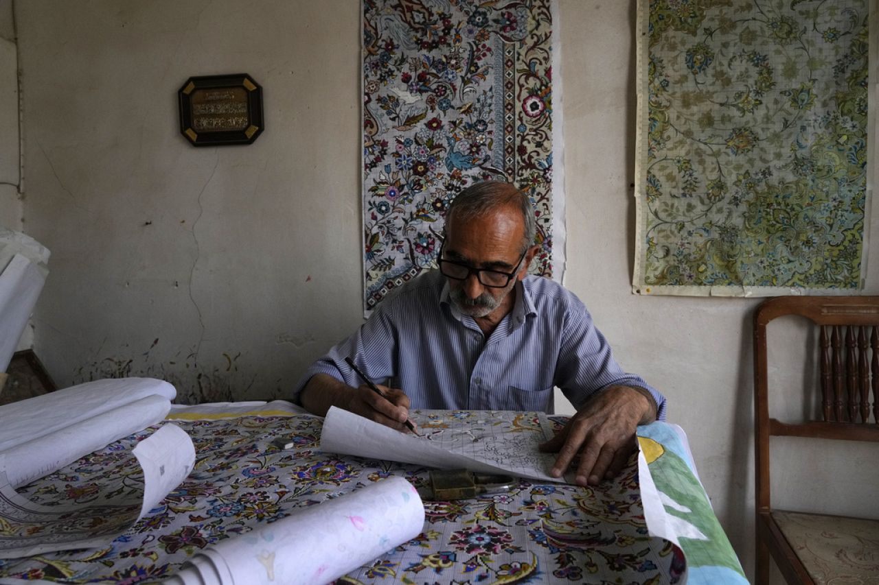 Iranian carpet designer Javad Amorzesh, one of just a few of Kashan's old-school artists, works at his workshop at the traditional bazaar of the city of Kashan, Iran.