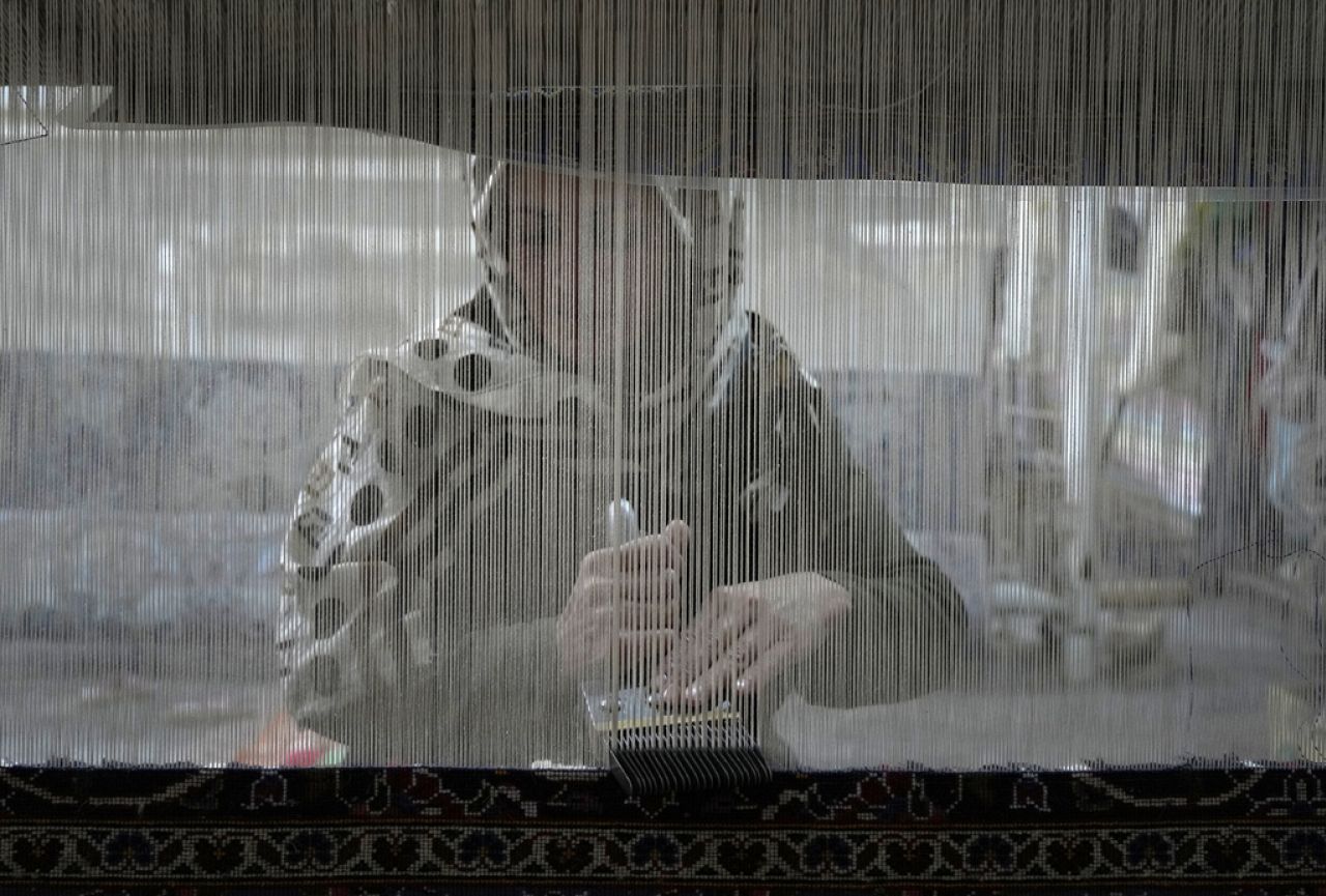An Iranian woman weaves a carpet at a workshop in the city of Kashan, about 152 miles (245 km) south of the capital Tehran, Iran, Tuesday, April 30, 2024.