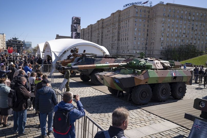 Visitors look at a French-made AMX-10RC armored vehicle at an exhibition of Western military equipment captured from Kyiv forces, Moscow on Friday, May 3, 2024.