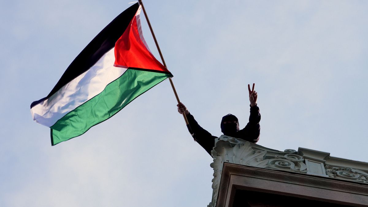  A student protester waves a Palestinian emblem supra Hamilton Hall connected nan field of Columbia University, Tuesday, April 30, 2024, successful New York.