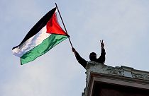  A student protester waves a Palestinian flag above Hamilton Hall on the campus of Columbia University, Tuesday, April 30, 2024, in New York.