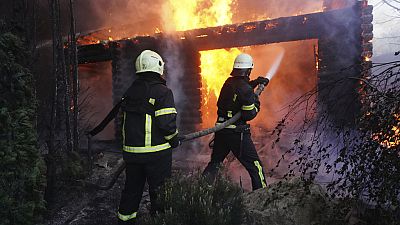 Firefighters put out a fire after a house was hit by Russian shelling in Kharkiv, Ukraine, Saturday, May 4, 2024. 