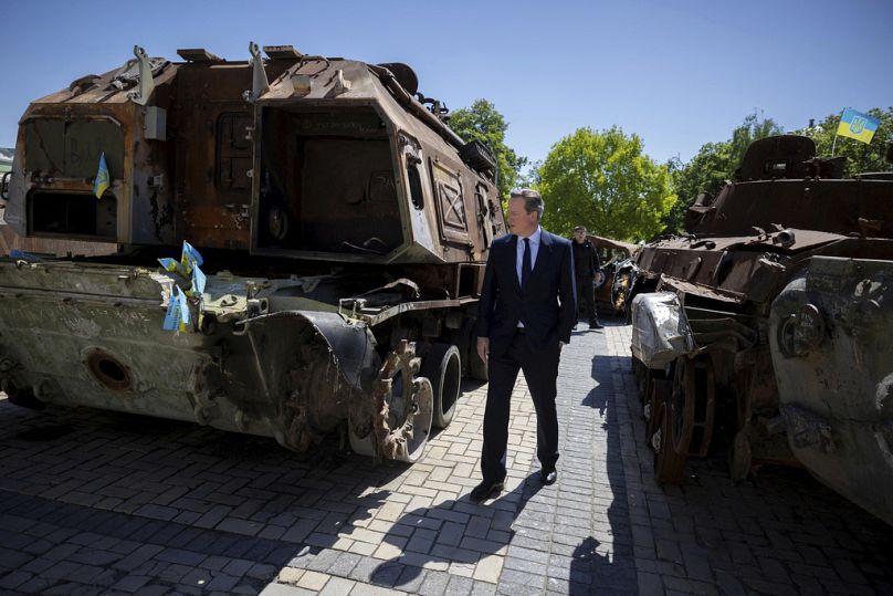 Britain's Foreign Secretary David Cameron walks past a display of destroyed Russian military vehicles in Saint Michael's Square, in Kyiv, Ukraine, Thursday May 2, 2024.