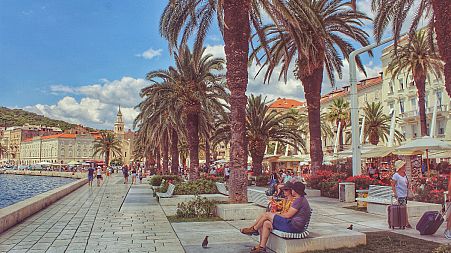 Wish you were here? Tourists enjoy the waterfront in Split, Croatia