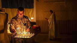 An Ukrainian serviceman of the 72nd Separate Mechanized Brigade, lights candles during a Christian Orthodox Easter religious service, in Donetsk region, Ukraine, 4 May, 2024.