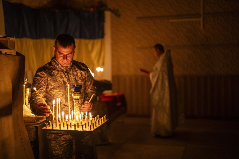 A Ukrainian serviceman of the 72nd Separate Mechanized Brigade, lights candles during a Christian Orthodox Easter religious service, in Donetsk region, Ukraine.