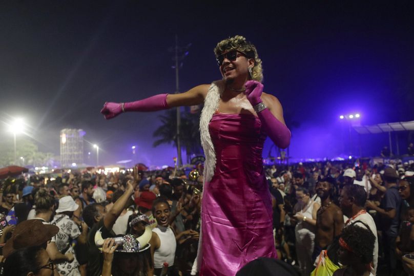 A Madonna fan dances while waiting for Madonna's show to begin, wearing a costume inspired by her video for "Material Girl."