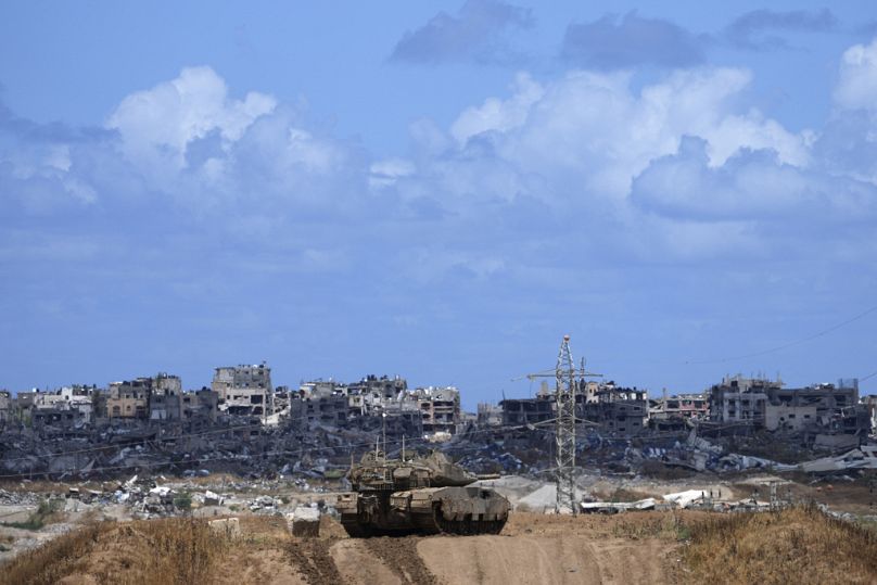 An Israeli tank overlooks the Gaza Strip, as seen from southern Israel, 6 May 2024