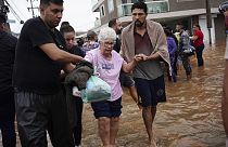 Residents evacuate from a neighborhood flooded by heavy rains, in Canoas, Rio Grande do Sul state, Brazil on Saturday