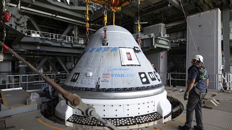 In this photo provided by NASA, the Boeing Starliner spacecraft is lifted at the Vertical Integration Facility at Space Launch Complex-41 at Cape Canaveral Space Force Station