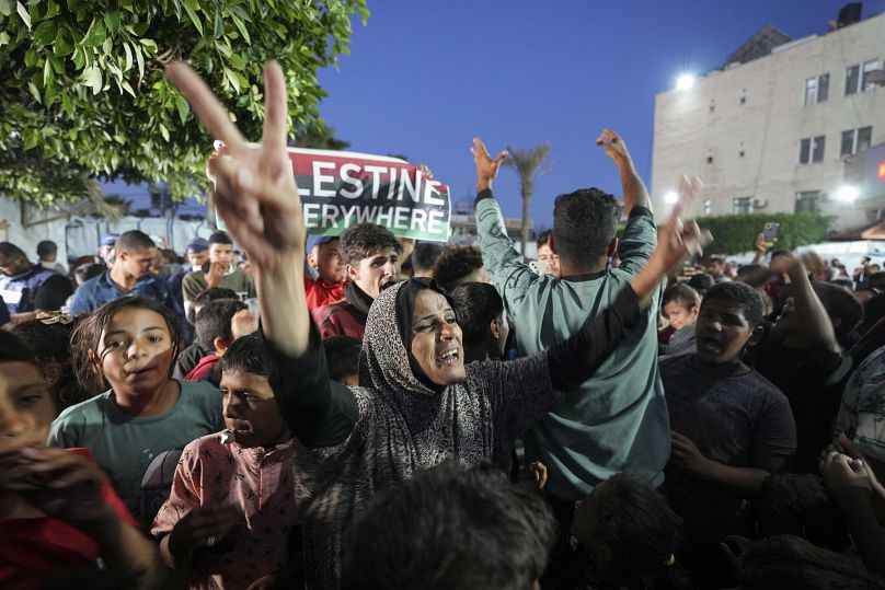 Palestinians celebrate in the streets of Deir al-Balah following Hamas's announcement that it accepted a ceasefire proposal, May 6, 2024