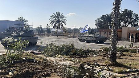A photo provided by the Israel Defense Forces shows a tank with an Israel flag on it entering the Gazan side of the Rafah border crossing on Tuesday, May 7, 2024.