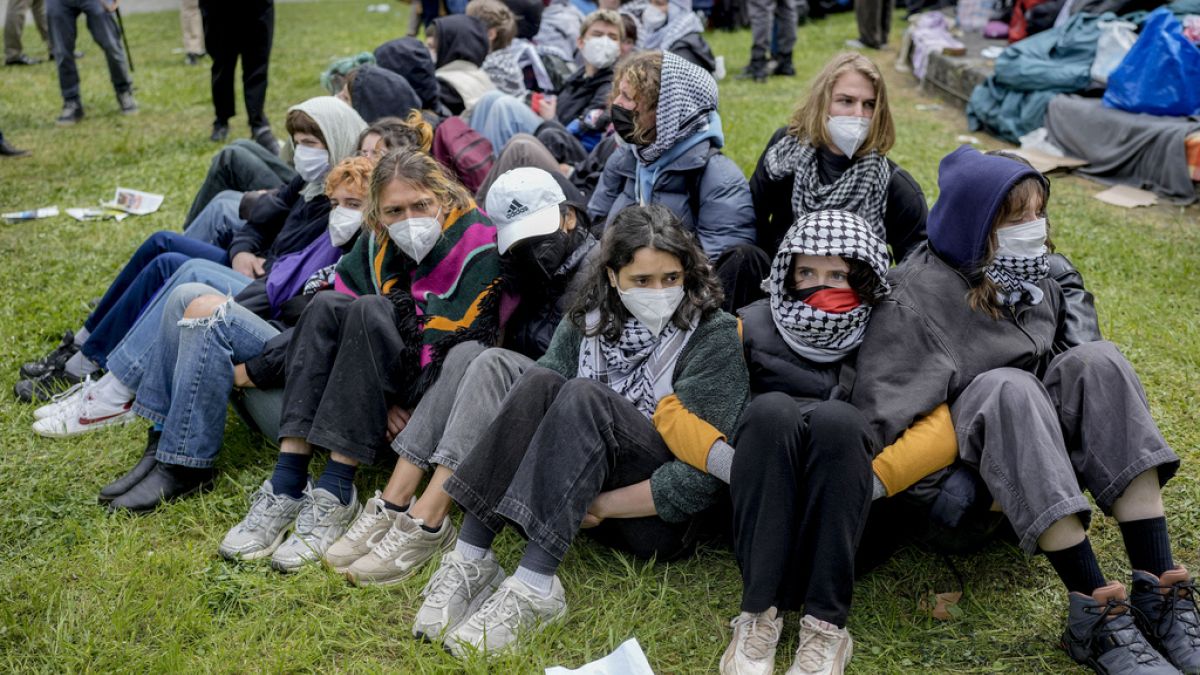 Participants sitting together during a pro-Palestinians demonstration  in the theater courtyard of the 'Freie Universität Berlin' university  (AP Photo/Markus Schreiber)