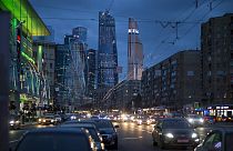 Traffic fills the multi-lane highway, along a main thoroughfare in Moscow, with the modern city skyscrapers illuminating the skyline in Moscow, Russia, Friday, July 8, 2016.