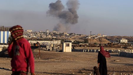 Smoke rises following an Israeli airstrike on buildings near the wall between Egypt and Rafah, May 7, 2024