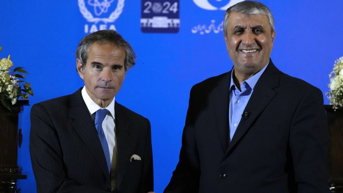 International Atomic Energy Organization, IAEA, Director General Rafael Grossi, left, and head of Iran's atomic energy department Mohammad Eslami shake hands at the conclusion