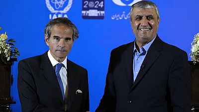 International Atomic Energy Organization, IAEA, Director General Rafael Grossi, left, and head of Iran's atomic energy department Mohammad Eslami shake hands at the conclusion