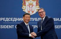 Chinese President Xi Jinping shakes hands with Serbian President Aleksandar Vucic.