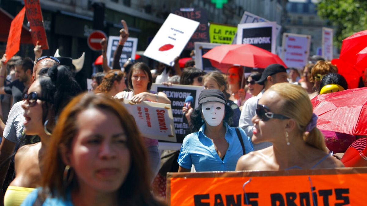 A French sex worker holds a banner reading "Without rights" at a march in Paris, 2 June, 2011