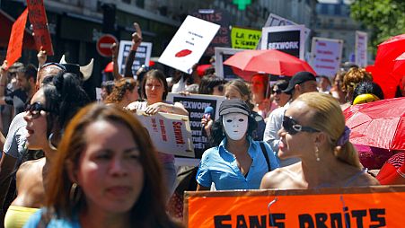 A French sex worker holds a banner reading "Without rights" at a march in Paris, 2 June, 2011