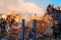 Rescuers work at a damaged building after a Russian missile attack in Ukraine's Kyiv region.