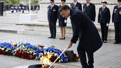 الرئيس الفرنسي إيمانويل ماكرون يوقد شعلة قبر الجندي المجهول
