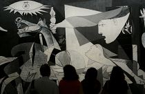 Visitors look at Picasso's "Guernica" at the Reina Sofia museum in Madrid, Spain