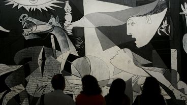 Visitors look at Picasso's "Guernica" at the Reina Sofia museum in Madrid, Spain