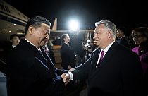In this image provided by the Hungarian Prime Minister's Office, Chinese President Xi Jinping, left, shakes hands with Hungarian Prime Minister Viktor Orban as