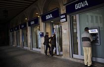 A man uses an ATM at a bank in Pamplona northern Spain