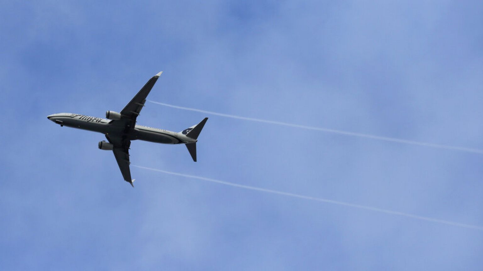 FILE - An Alaska Airlines Boeing-made airplane flies above Boeing's newly expanded 737 delivery center, Monday, Oct. 19, 2015.