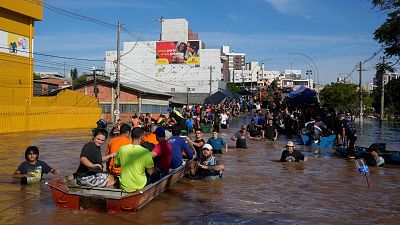 Volunteers gather in order to help residents evacuate from an area flooded by heavy rains, in Porto Alegre, Brazil.