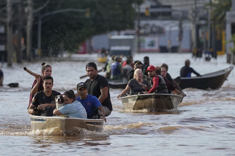 Volunteers help to evacuate residents from an area flooded by heavy rains, in Porto Alegre, Brazil.