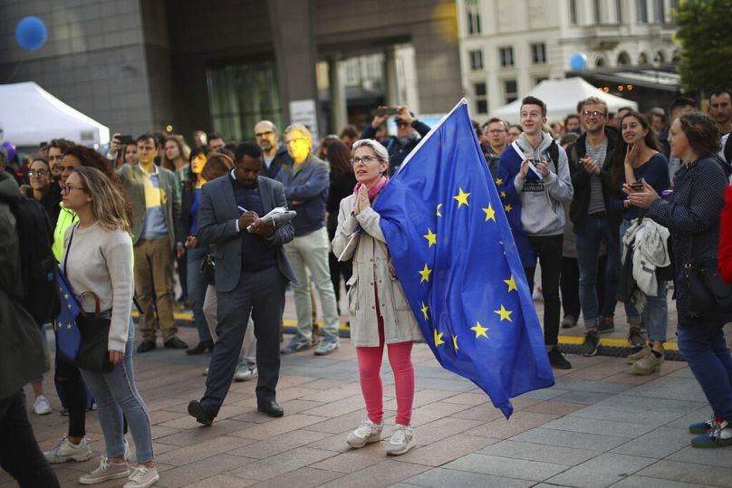 A woman holds an EU flag during a festival outside the European Parliament in Brussels, May 2019