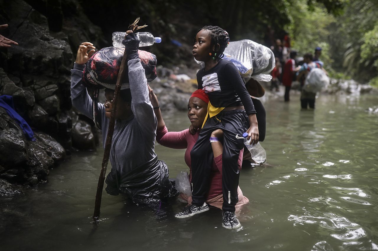 Haitian migrants wade through water as they cross the Darien Gap from Colombia to Panama in hopes of reaching the US