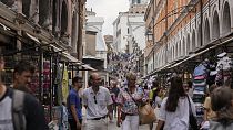 FILE -Tourists walk in a crowded street in Venice, Italy, Wednesday, Sept. 13, 2023.