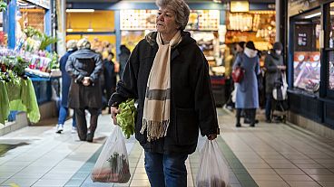 Customers purchase food in Budapest's Grand Market Hall on Saturday, April 8, 2023.
