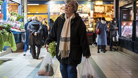 Customers purchase food in Budapest's Grand Market Hall on Saturday, April 8, 2023.