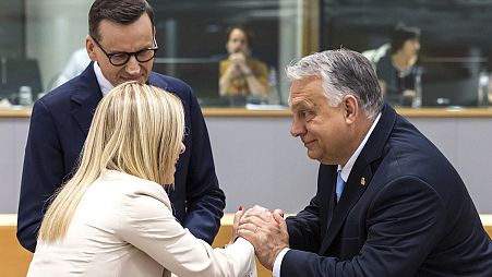 Hungary's Prime Minister Viktor Orban, right, speaks with Italy's Prime Minister Giorgia Meloni, centre, and Poland's former Prime Minister Mateusz Morawiecki, left 