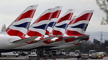 In this Wednesday, March 18, 2020 file photo, British Airways planes parked at Terminal 5 Heathrow airport in London.