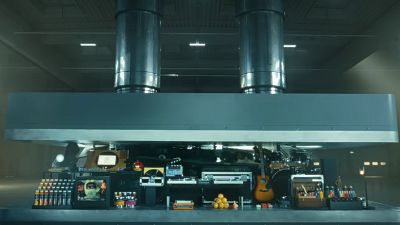  A hydraulic press crushes an array of creative instruments in a still from Apple's new ad