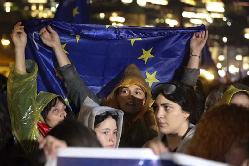 Protesters hold an EU flag during a protest rally against "the Russian law" in Tbilisi, Georgia, Saturday, May 11, 2024.