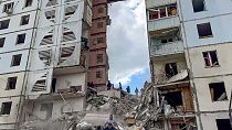 Russian emergency services work at the scene of a partially collapsed block of flats authorities said was hit during an attack by Ukrainian shelling, in Belgorod, Russia